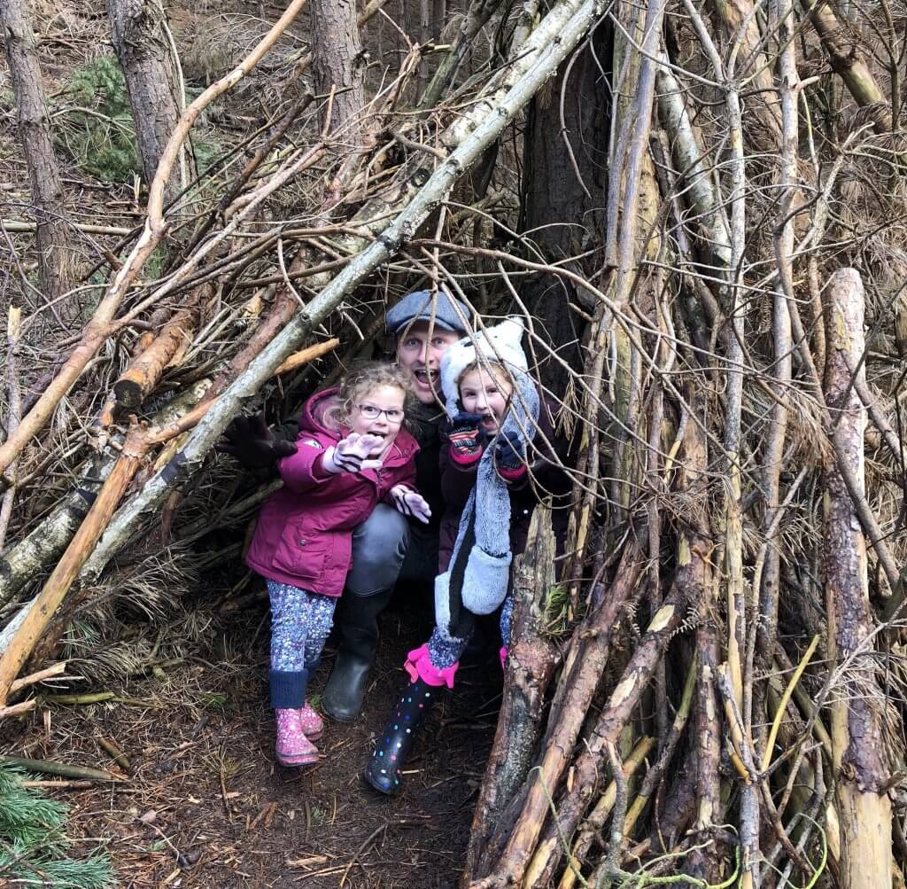 My girls and daddy in woodland den - free half-term activities